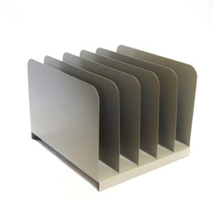 May include: A silver-colored metal desk organizer with six vertical dividers. The organizer has a rectangular base and a curved top on each divider. The design is minimalist and modern, suitable for office or home use.