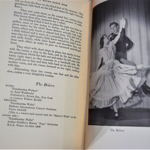 May include: A black and white photograph of a couple dancing the bolero. The woman is wearing a long, flowing skirt and the man is wearing a suit. The caption below the image reads "The Bolero."