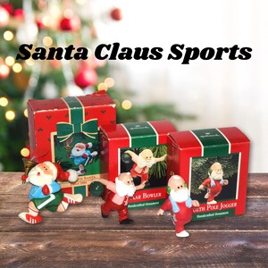 May include: Christmas ornaments featuring Santa Claus in various sports poses, including bowling and jogging. The ornaments are red, white, and green, with the text "Santa Claus Sports" on the image. The ornaments are in their original boxes.