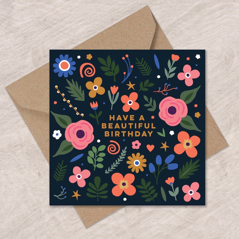 May include: A dark blue birthday card with a floral pattern and the text "Have a beautiful birthday" in gold lettering.