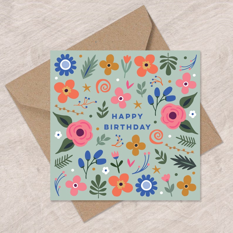 May include: A light blue card with a floral pattern and the text "Happy Birthday" in blue. The flowers are pink, orange, yellow, and blue.
