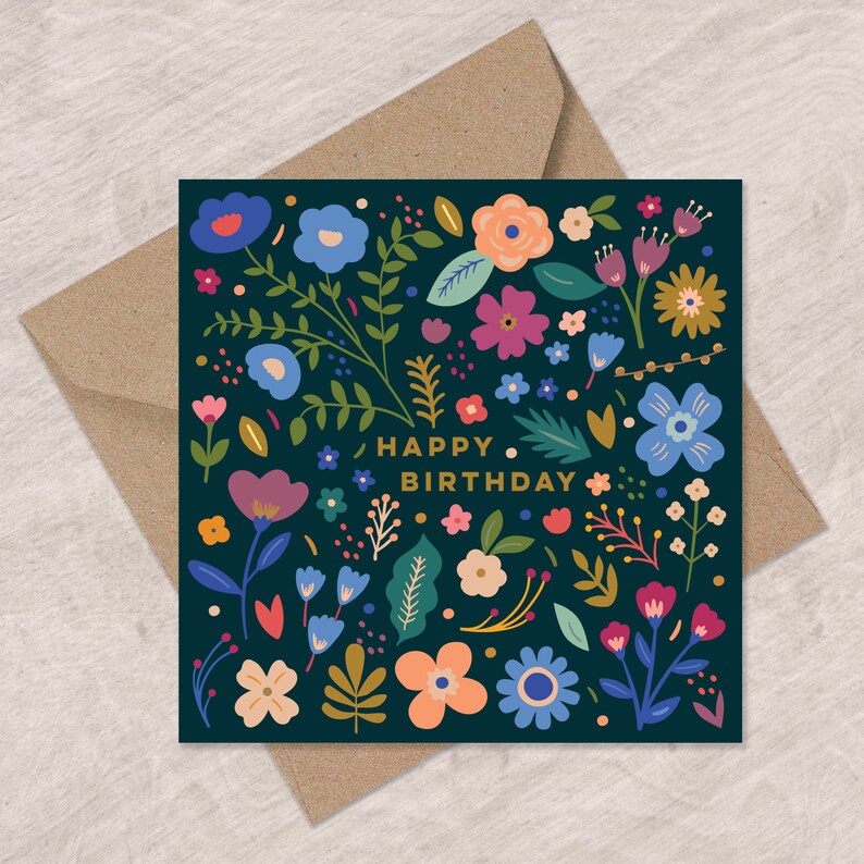 May include: A dark blue card with a floral pattern and the text "Happy Birthday" in gold lettering.
