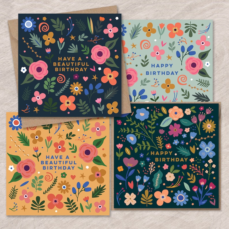 May include: Four different birthday cards with floral designs. The cards have a dark blue, light blue, dark green, and yellow background. The text on the cards reads "Have a beautiful birthday" and "Happy birthday".