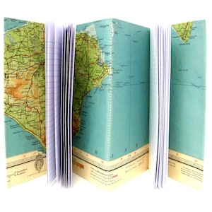May include: A vintage-style notebook with a map of the Isle of Wight on the cover. The notebook is open to reveal lined pages.