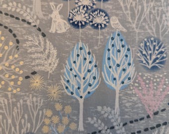 May include: A fabric with a whimsical forest design. The pattern features stylized trees with blue and white leaves, rabbits, and an owl. The background is a soft grey with accents of white, gold, and pink.