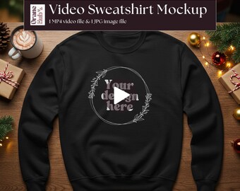 May include: Black sweatshirt mockup with the text "Your design here" inside a circular floral design. The image also includes the text "Video Sweatshirt Mockup" and "1 MP4 video file & 1 JPG image file".