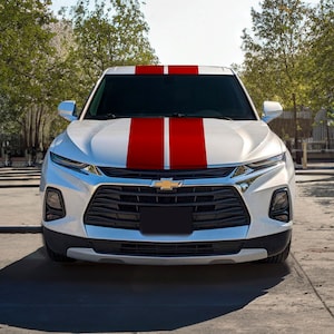 May include: White SUV with red racing stripes on the hood.