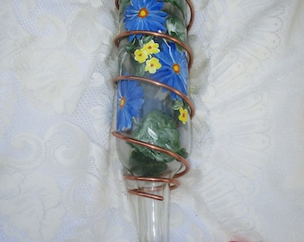 Wine bottle hummingbird feeder with hand painted blue daisy floral design.