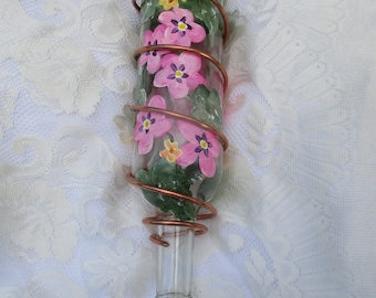 Wine Bottle hummingbird feeder with wrapped copperwire.  Pink and Lavender floral design.