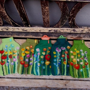Hot water bottle with felted cover, grass and flowers, green