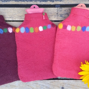 Hot water bottle with felted cover, coloured dots on red