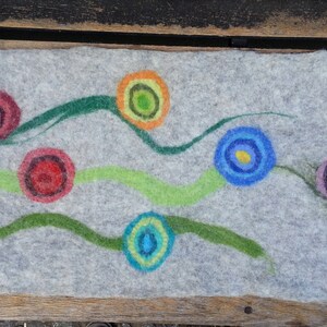 May include: A gray felt runner with colorful circles and green lines. The circles are in shades of red, orange, yellow, blue, and purple.