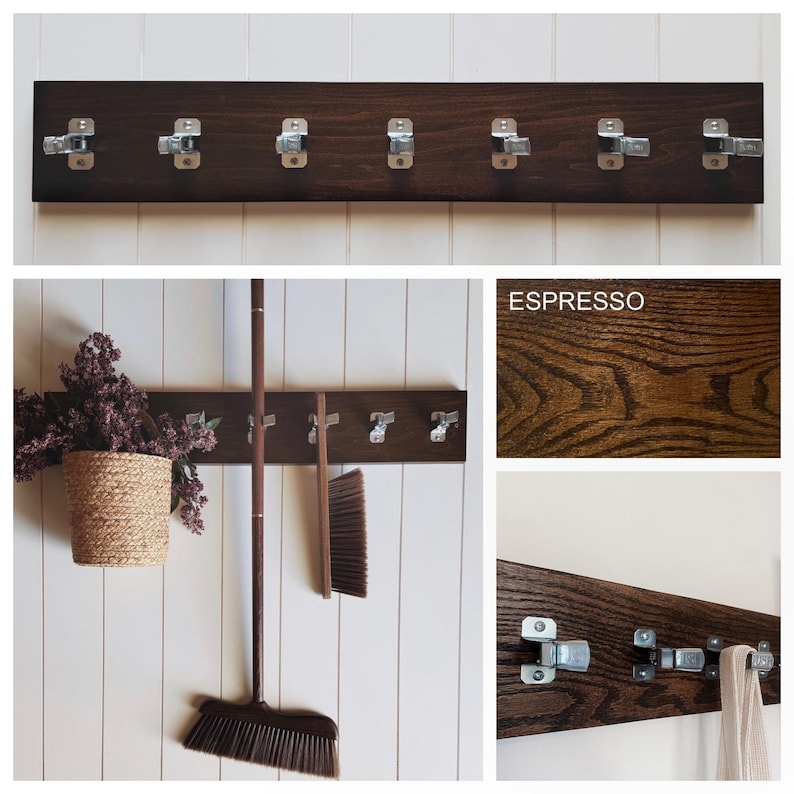 May include: A dark brown espresso-stained wooden wall rack featuring seven silver metal spring-loaded clips for hanging items. The rectangular board displays a visible wood grain texture and is shown holding a broom and a cloth.