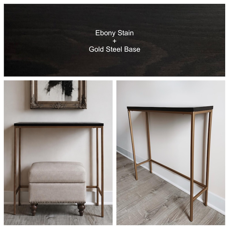 May include: A console table featuring a rectangular top with an ebony stain and a gold steel base. The text Ebony Stain + Gold Steel Base is visible. The table is shown with a beige upholstered ottoman with dark wooden feet and nailhead trim.