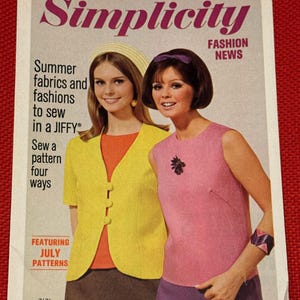 May include: A vintage Simplicity Fashion News sewing pattern catalog cover featuring two individuals. One wears a yellow jacket over an orange top and a dark skirt. The other wears a pink sleeveless top with a dark brooch and a purple skirt.