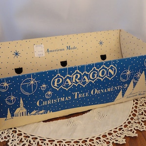 May include: A blue and white cardboard box with the words 