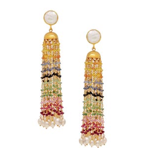 May include: A pair of gold-toned tassel earrings. Each earring features a white, circular top, a gold-colored bell-shaped base, and a long tassel of colorful beads. The beads transition from yellow to red, with white pearls at the bottom.