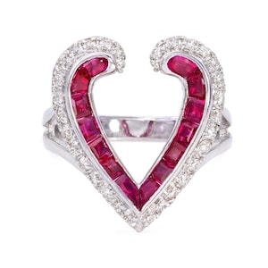 May include: A heart-shaped ring with a white gold band and a setting of red rubies and white diamonds.