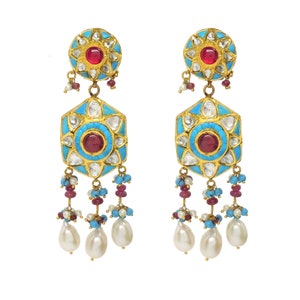 May include: A pair of gold earrings with turquoise and white enamel, red gemstones, and pearl drops.
