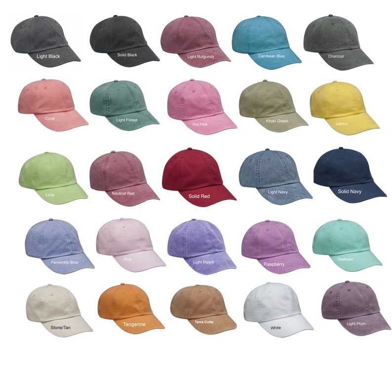 May include: A collection of twenty-five baseball caps in various colors, including black, burgundy, blue, green, pink, and yellow. Each cap has a curved brim and a fabric strap closure. The caps are arranged in rows and columns.