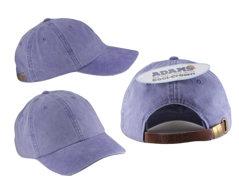 May include: A purple cotton baseball cap with a brown leather strap and a label that reads "ADAMS cool-crown".
