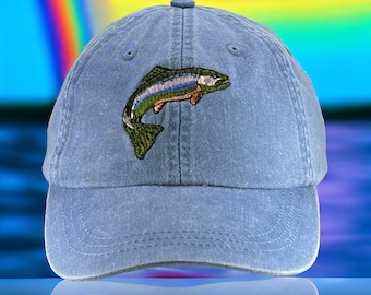 May include: A blue denim baseball cap with an embroidered trout design. The trout is green, brown, and orange.