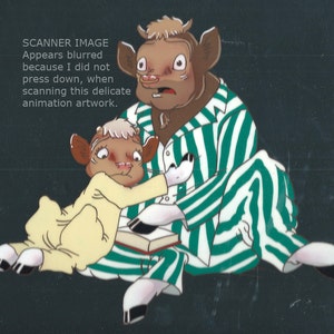 May include: Two cartoon cows in pajamas, one wearing a yellow and the other wearing a green and white striped pajama set. The cow in the yellow pajamas is holding a book.