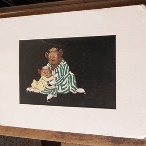 May include: A black and white illustration of two cartoon cows wearing pajamas. The cow on the left is wearing yellow pajamas and the cow on the right is wearing green and white striped pajamas.