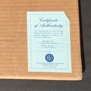 May include: A blue certificate of authenticity for a hand-painted animation cel from the Duck Soup production series. The certificate is from Borden's Animation Studio and the International Animated Film Society (ASIFA Hollywood).