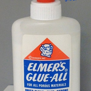 May include: A white plastic bottle of Elmer's Glue-All with a red cap. The label is blue and red with the text "Elmer's Glue-All" and "For all porous materials". The bottle contains 4 fluid ounces (118 ml) of glue.