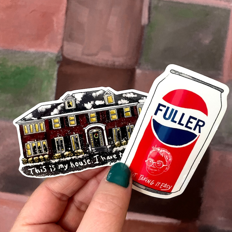 May include: Two stickers, one featuring a cartoon house with the text "This is my house. I have t" and the other featuring a can of soda with the text "FULLER" and "OT TAKING IT EASY".