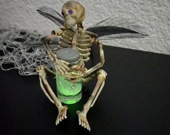 Skeleton Fairy Holding Glow-in-the-Dark Potion Bottle | spooky Halloween skeleton décor