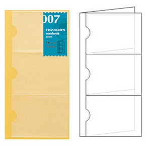 May include: A clear, three-pocket insert for a Traveler's Notebook. The insert is a light yellow color with rounded cutouts for easy access. A blue label with the text "007 Traveler's Notebook" is on the top left.