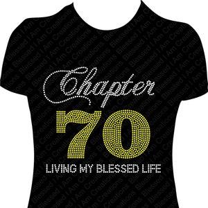 May include: Black t-shirt with the text "Chapter 70" in white and yellow rhinestones. The phrase "LIVING MY BLESSED LIFE" is below the number 70. A birthday-themed shirt.