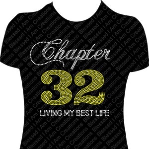 May include: Black t-shirt with a rhinestone design that says "Chapter 32 Living My Best Life".
