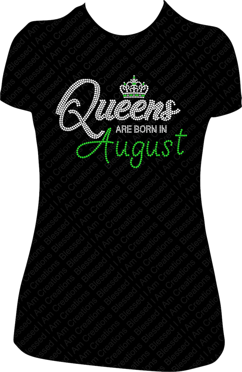 May include: Black t-shirt with a white rhinestone design that says "Queens are born in August" with a green rhinestone crown above the word "Queens".