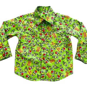 May include: Green long-sleeved shirt with a repeating pattern of the Grinch's face and the text "You're a Mean One, Mr. Grinch!"