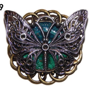Steampunk pin badge brooch silver butterfly on a bronze, blue and green backing #CG09