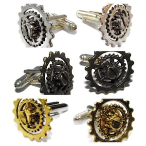 May include: Three pairs of cufflinks with a gear design. The cufflinks are silver, bronze, and gold.
