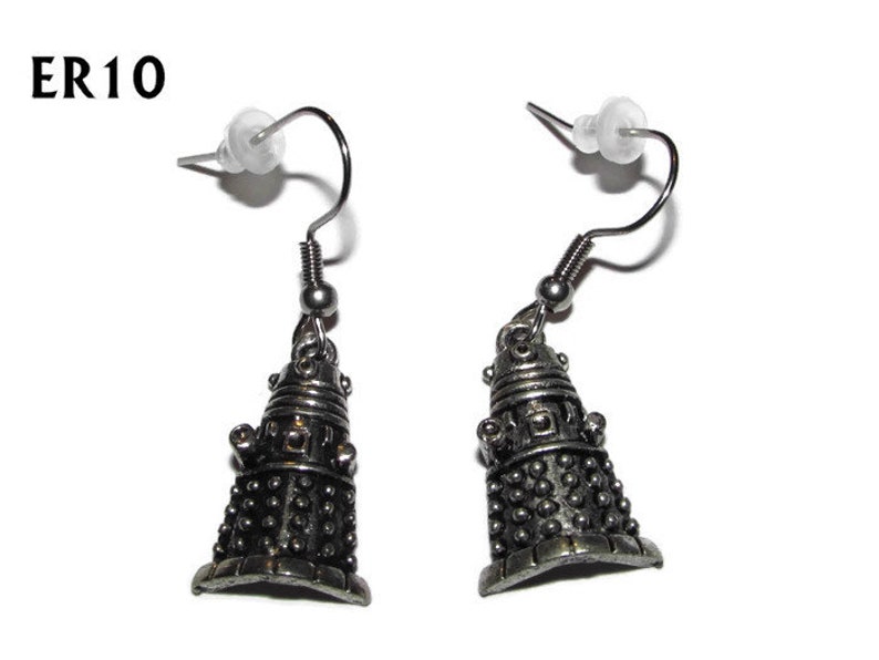 May include: A pair of silver earrings featuring a detailed Dalek design. The earrings are on a silver hook.
