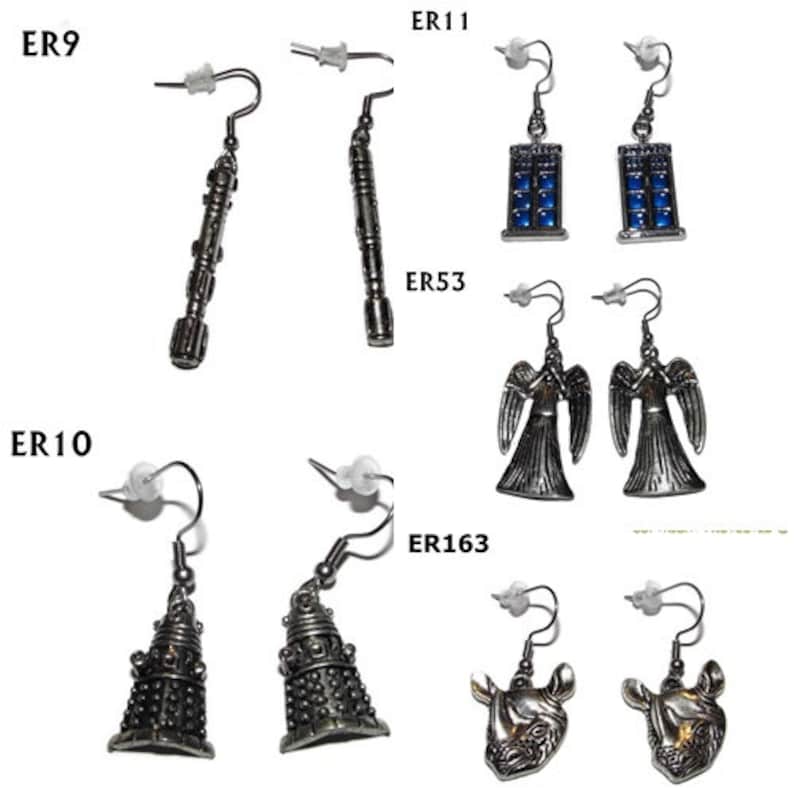 May include: A set of 10 pairs of silver-toned earrings featuring various Doctor Who themed designs, including the TARDIS, Daleks, and Weeping Angels. The earrings are labelled with their corresponding product codes: ER9, ER10, ER11, ER53, and ER163.