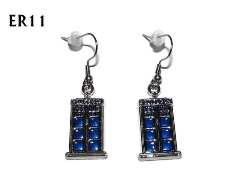 May include: A pair of silver earrings with blue enamel TARDIS designs. The earrings have a hook fastening.
