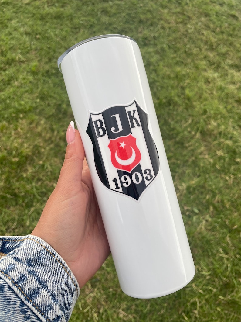 May include: White stainless steel tumbler with a black and white logo featuring the text "BJK 1903" and a red crescent moon and star.