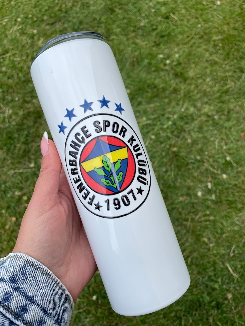 May include: White stainless steel tumbler with a blue, yellow, and red logo that says "Fenerbah&ccedil;e Spor Kul&uuml;b&uuml; 1907" with five blue stars above the logo.