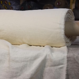 Pure linen fabric. It has a very slight tint of creamy/yellowish/grayish and even a pinkish at the same time, very pale, milky, smooth and buttery. The fabric is middle weight, strong and durable, densely and plain woven, not sheer.