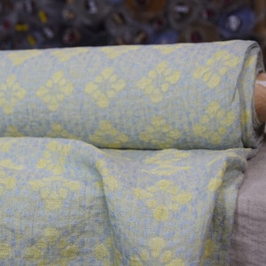 Pure linen fabric Flora Breezy. Floral geometric jacquard pattern woven from pastel yellow and pastel blue colors. Pattern repeats at each 6cm. The oposite sides of the fabric are different but both sides can be used as a right side.