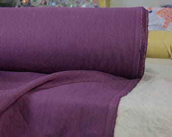 May include: A roll of deep purple linen fabric. The fabric is folded and has a soft, textured surface.