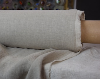 May include: A roll of natural linen fabric with a slightly textured surface. The fabric is light beige in color and is rolled up on a cardboard tube.