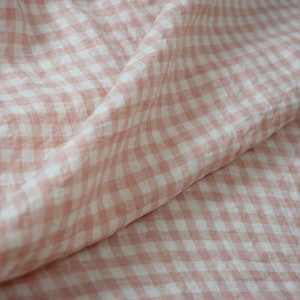 Pure linen fabric Aurora Blush Pink Gingham. The fabric is dense, not sheer, naturally wrinkled. Clolors of the gingham are white and pale pink. Cells are 8mm. The fabric is aesthetic, strong, durable, organic, pleasant to touch, pre-shrunk.