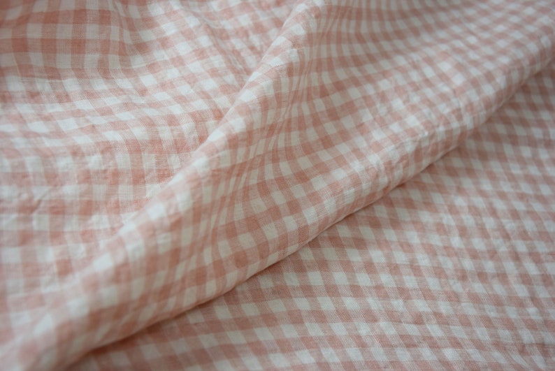 Pure linen fabric Aurora Blush Pink Gingham. The fabric is dense, not sheer, naturally wrinkled. Clolors of the gingham are white and pale pink. Cells are 8mm. The fabric is aesthetic, strong, durable, organic, pleasant to touch, pre-shrunk.